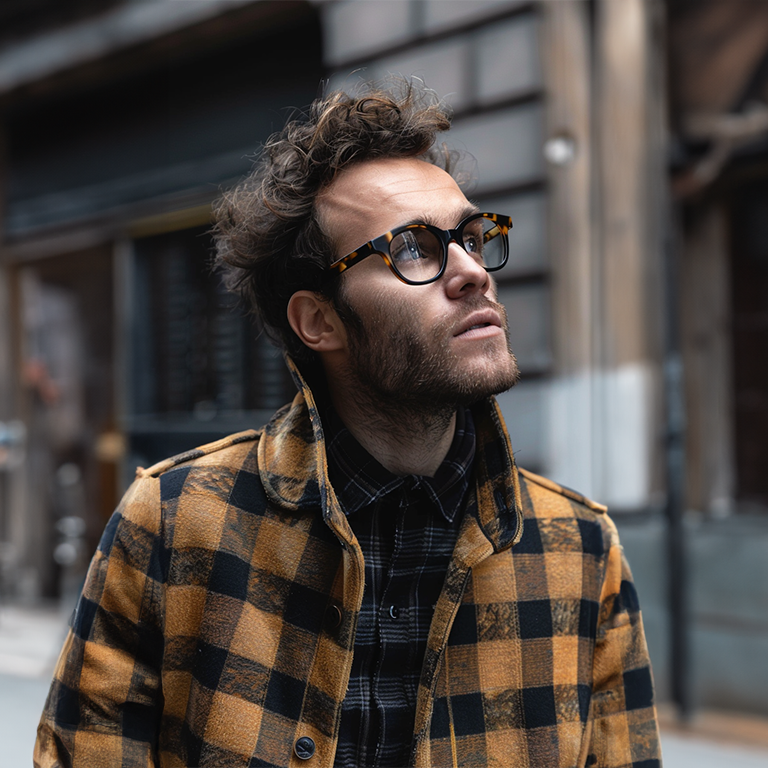 Man in plaid coat looking upward