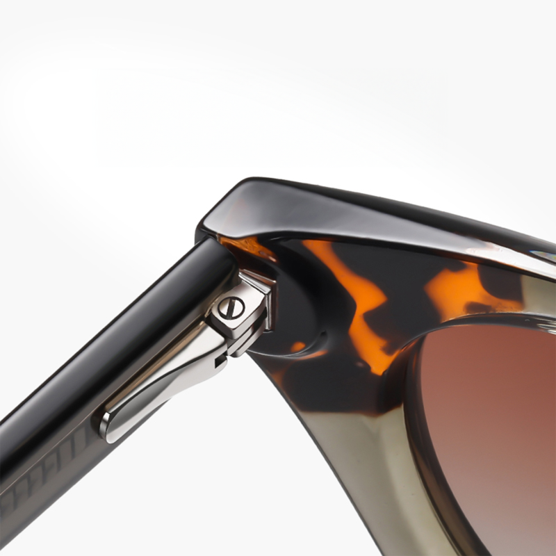 Close-up of tortoiseshell sunglasses hinge and frame.
