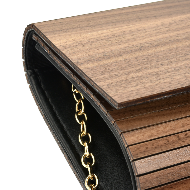 Wooden clutch bag with gold chain detail.