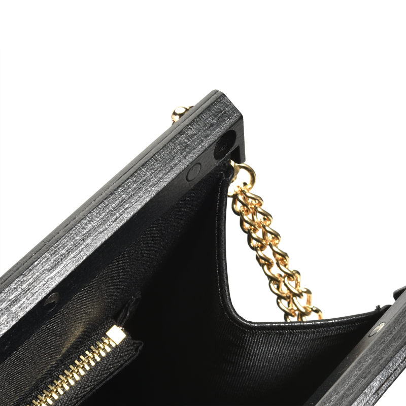 Black clutch purse with gold chain strap.