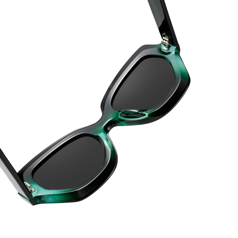 Stylish green and black sunglasses on white background.