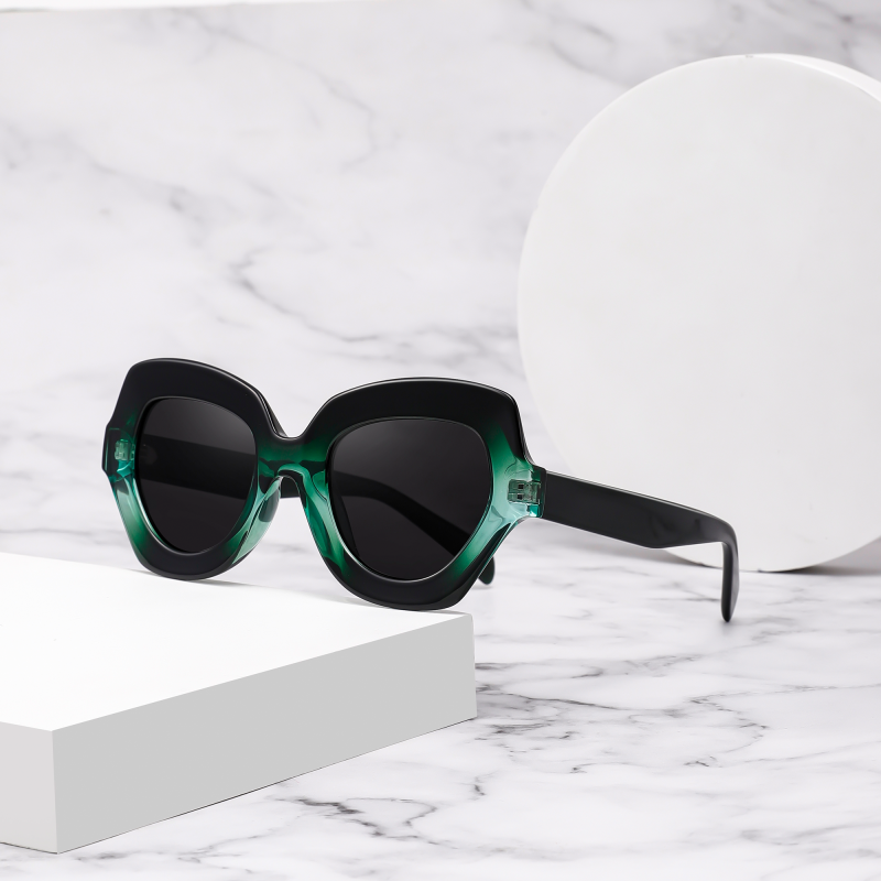Green sunglasses on marble surface