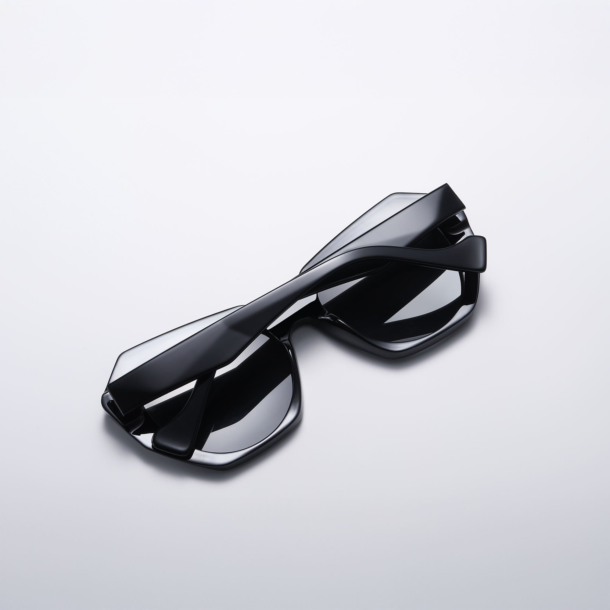 mercer by find unusual black closed Stylish black sunglasses on white background.