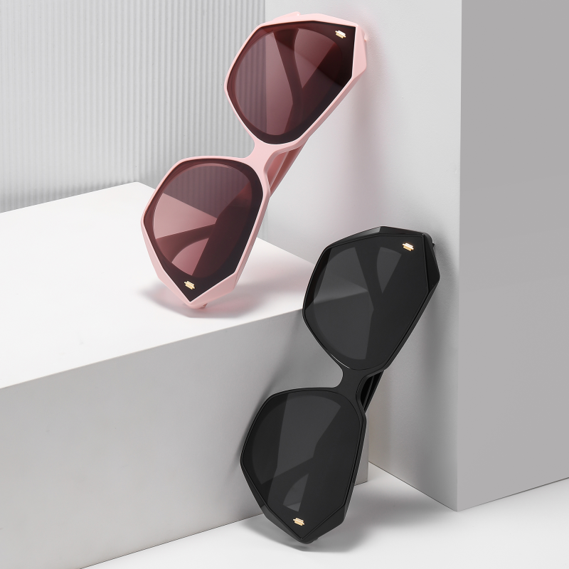 Black and pink geometric sunglasses displayed stylishly.