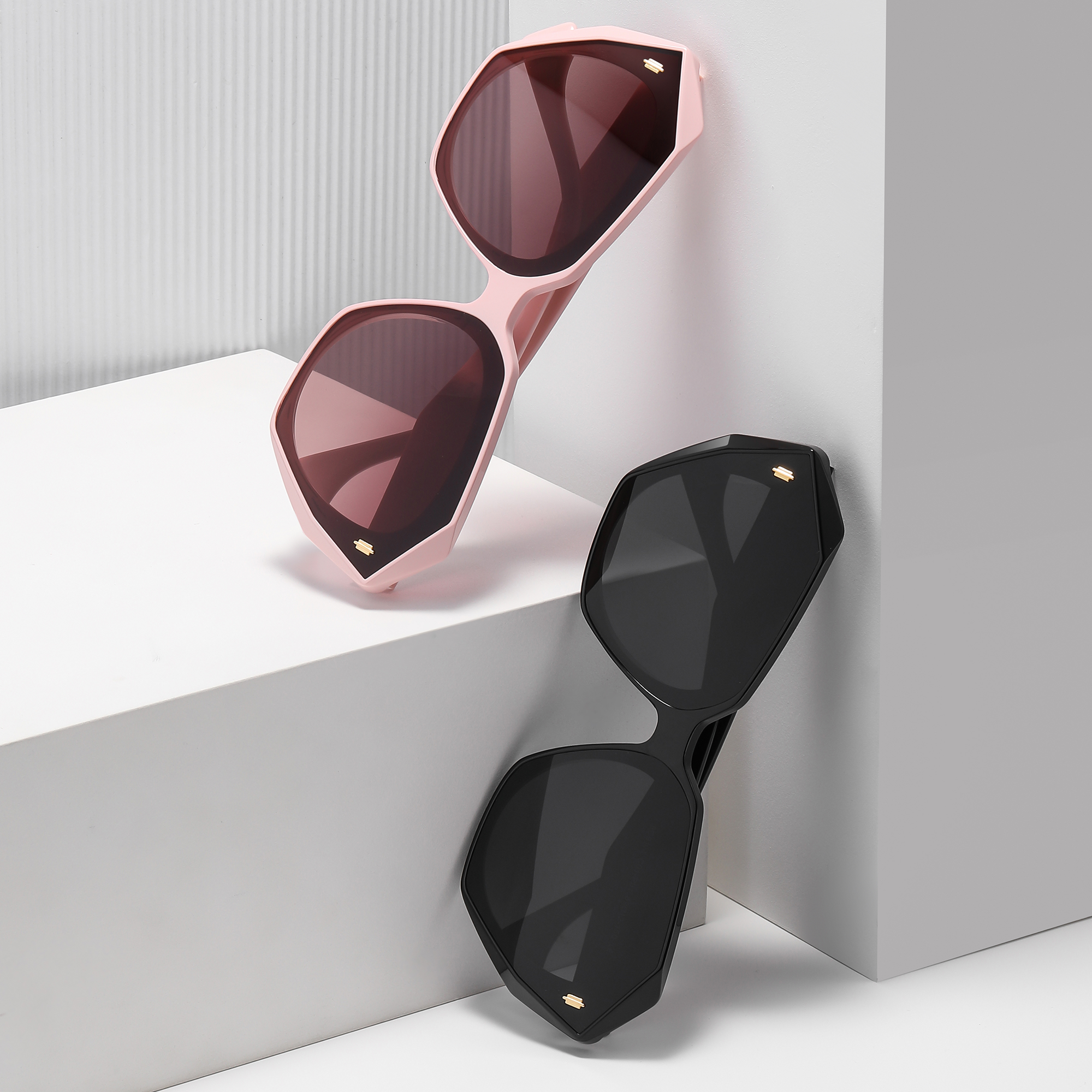 mercer by find unusual lifestyle pink and black Black and pink geometric sunglasses displayed stylishly.