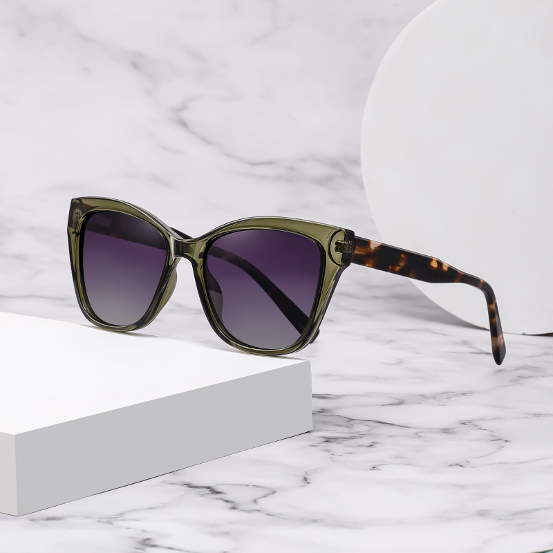 Stylish green sunglasses on marble surface.