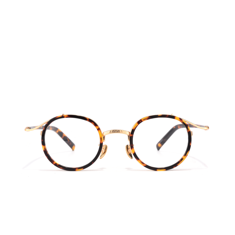 Round tortoiseshell eyeglasses with gold accents.