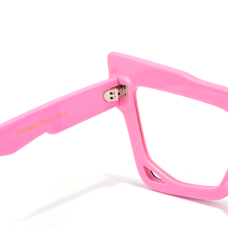 Close-up of pink eyeglass frame hinge