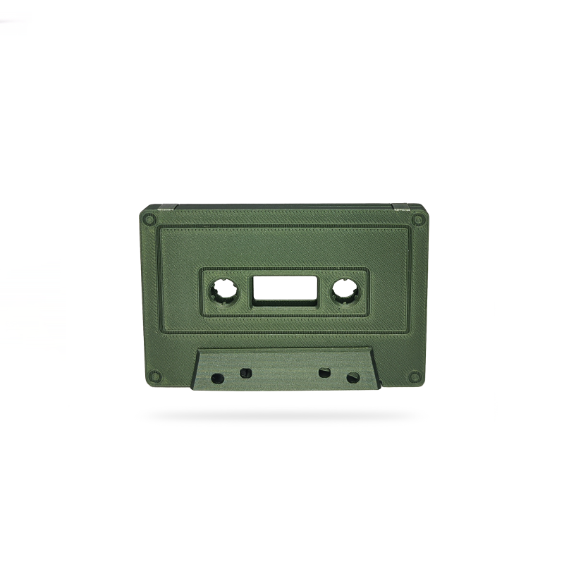 Green cassette tape on white background