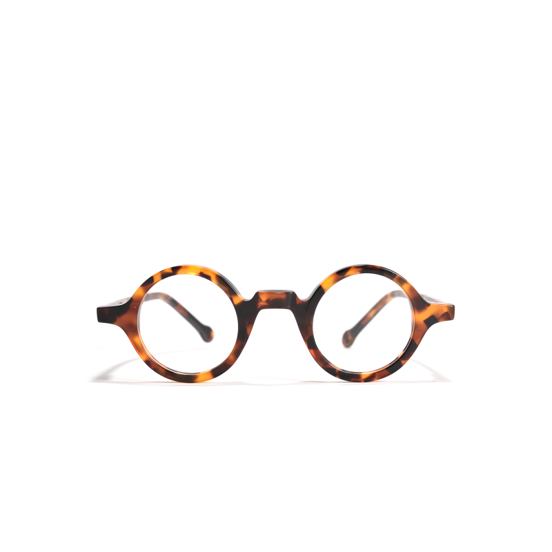 Round tortoiseshell eyeglasses on white background.