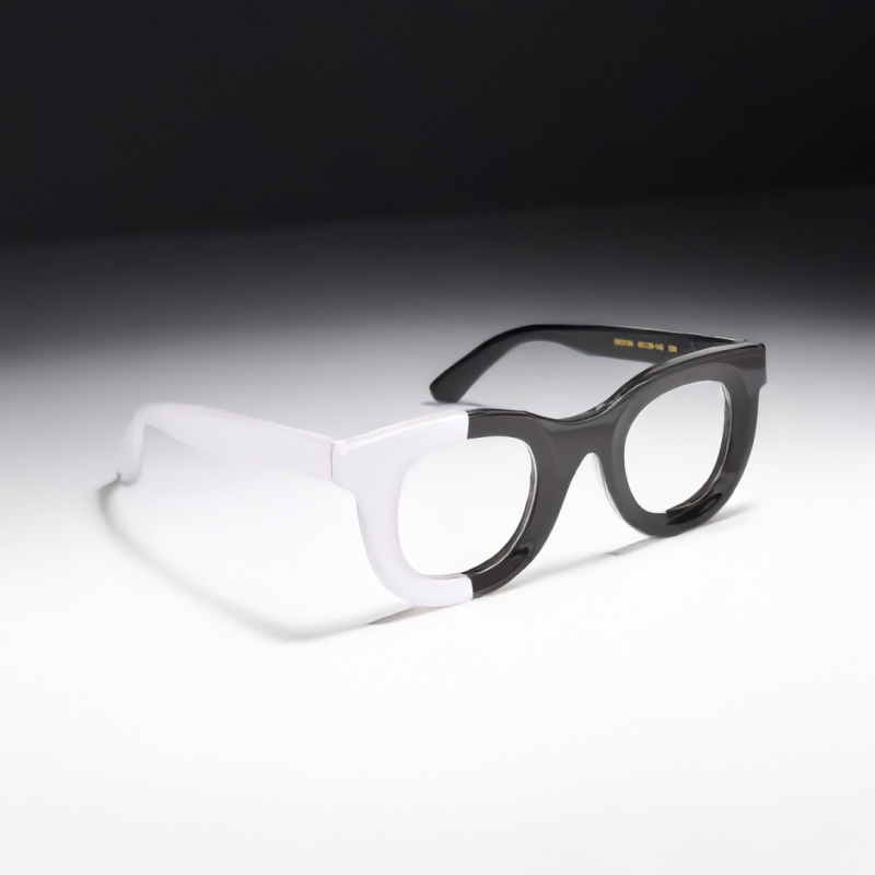 Two-tone black and white glasses on table.